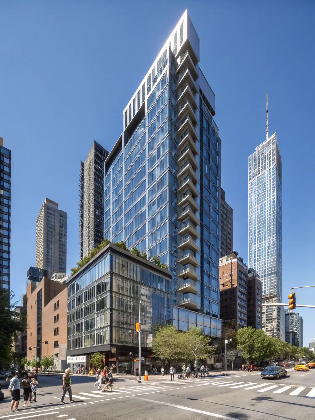 A well-maintained apartment building exterior in a bustling NYC neighborhood, showcasing the quality of properties managed by Building It Together PM.
